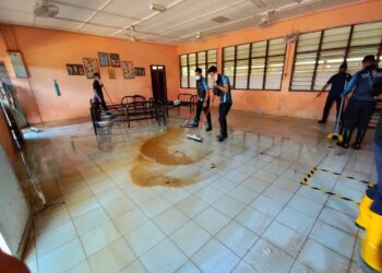 ANGGOTA polis dari Ibu Pejabat Polis Daerah (IPD) Dungun antara yang membantu membersihkan SK Pasir Raja baru-baru ini.