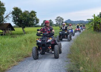 TUANKU Syed Faizuddin Putra Jamalullail yang merasmikan ATV Bintong meluangkan masa hampir sejam menaiki kenderaan lasak itu ‘meronda kampung’ bersama yang lain di Bintong, Perlis hari ini.- UTUSAN/IZLIZAN OTHMAN