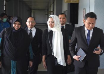 EMILIA Hanafi (tengah) diiringi peguam pemerhatinya hadir di Mahkamah Majistret Kuala Lumpur bagi perbicaraan kes S.M. Faisal S.M. Nasimuddin yang didakwa mencederakannya. -  UTUSAN/AMIR KHALID