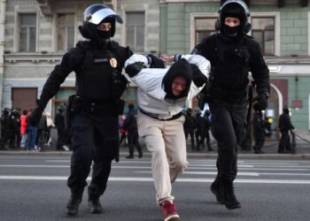 ANGGOTA polis menahan seorang penunjuk perasaan yang menyertai protes kerahan tenaga ke Ukraine di Saint Petersburg, Russia. - AFP