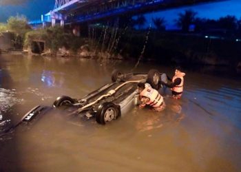 ANGGOTA Bomba dan Penyelamat berusaha mengeluarkan wanita warga emas yang terperangkap setelah kereta yang dinaikinya dipercayai terbabas dan terjunam ke dalam Sungai Pari di Ipoh, hari ini.  FOTO: IHSAN JBPM