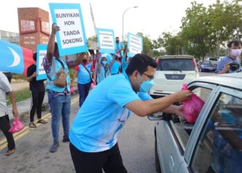 AKMAL Nasrullah Mohd. Nasir menyampaikan sumbangan ayam segar kepada penduduk secara pandu lalu di sekitar Taman Suria, Johor Bahru.