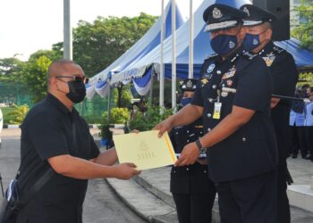 WARTAWAN sambilan Utusan Malaysia, Khairul Mohd. Ali menerima surat penghargaan daripada Kamarul Zaman Mamat sempena Hari Polis ke-215 di IPK Johor. - UTUSAN/RAJA JAAFAR ALI