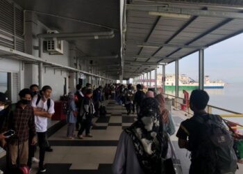 PENUMPANG berbaris untuk menaiki feri ke Pulau Langkawi di Jeti Kuala Perlis, Perlis. - UTUSAN/SHAHIR NOORDIN