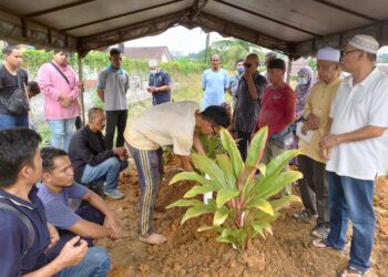 MUHAMMAD FIKRI ABDUL MUBIAN (duduk, dua dari kiri) tenang melihat jenazah dua anaknya dikebumikan dalam satu liang lahad di Tanah Perkuburan Islam Mukim Tebrau, di Taman Istimewa, Johor Bahru.