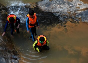 TIGA kanak-kanak menikmati Air Terjun Sungai Lasir, Tasik Kenyir, Hulu Terengganu. – UTUSAN/PUQTRA HAIRRY ROSLI