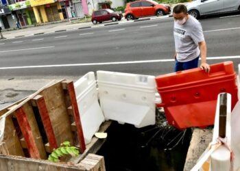 HONG Puan Chaw melihat penutup longkang yang terjatuh di depan premisnya di Jalan Sultan Yahya Petra, Kota Bharu, Kelantan, hari ini. - FOTO/ROSLIZA MOHAMED
