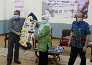 KAMARUDDIN Domat (kiri) menerima cendera mata daripada ‘Ainu Sham Razali selepas merasmikan penutup Program Pembangunan Kemahiran Komuniti di Putrajaya hari ini. - UTUSAN/AMREE AHMAD
