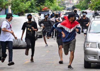 PESERTA protes melarikan diri daripada pihak berkuasa semasa demonstrasi menentang junta tentera di Yangon. -AFP