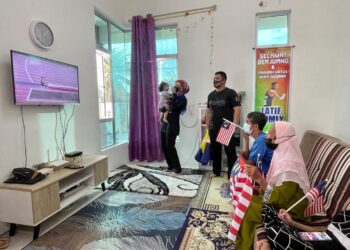 SALMAH YATIM (kanan) bersama Romly Mat (dua dari kanan) serta ahli keluarga mereka menyaksikan Abdul Latif dalam acara lompat jauh T20 Sukan Paralimpik 2020 di Taman Emas, Beseri, Padang, Besar, Perlis hari ini.- UTUSAN/NAZLINA NADZARI