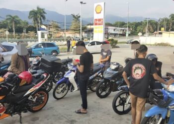 SEKUMPULAN remaja bermotosikal yang diperiksa anggota polis dalam  operasi khas di pekan Rembau, Negeri Sembilan.