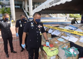 KAMARUL Zaman Mamat memeriksa sebahagian dadah yang akan dilupuskan di IPK Kedah, Alor Setar, Kedah, hari ini. - UTUSAN/MOHD. RAFIE AZIMI