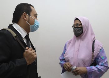 NUR Sakinah Abdullah, 54, berbincang bersama Pegawai Pendakwa Jabatan Veterinar, Mohammad Firdaus Mat Ludin (kiri) selepas didenda RM5,000 oleh Mahkamah Majistret Shah Alam di sini hari ini atas pertuduhan memiliki daging kerbau tidak disembelih pada Januari dan Februari lalu. -UTUSAN/SAIRIEN NAFIS