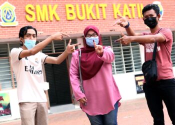 Pengundi muda (dari kiri) Muhamad Hanif Mohd Hanafi, 24, Nurain Shahidah Samsudin, 24, dan Ahmad Hassan Omar, 27, menunjukkan dakwat di jari selepas menunaikan tanggungjawab pada hari mengundi sempena Pilihan Raya Negeri (PRN) Melaka di Sekolah Menengah Kebangsaan Bukit Katil, Melaka.  - UTUSAN/ RASUL AZLI SAMAD