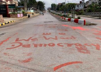 PESERTA protes menulis tulisan menggunakan cat berwarna merah di atas jalan di Taunggyi, Myanmar. - AFP