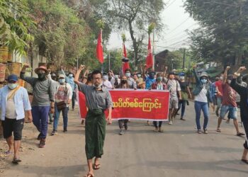 GAMBAR dari sumber tidak dikenali di Facebook menunjukkan peserta protes memegang kain rentang menentang rampasan kuasa junta tentera. -AFP