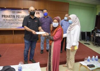 RONALD Kiandee Prihatin menyampaikan  bantuan kepada salah seorang penerima dalam majlis Prihatin Peladang anjuran Pertubuhan Peladang Kawasan Beluran, Sabah, hari ini.