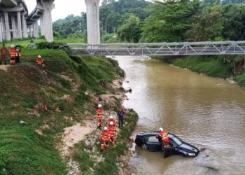 Anggota bomba dan penyelamat memeriksa kereta Audi A6 yang ditemukan di dalam sungai di bawah jejambat Jalan Lingkaran Tengah, Rasah, semalam.