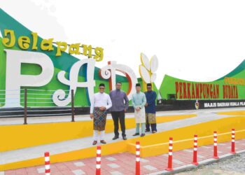 MOHD. FAIZAL ABDUL MANAP (kiri) bergambar berlatar belakangkan mercu tanda Jelapang Padi@Terachi tersebut selaras dengan usaha yang sedang giat dilaksanakan bagi meningkatkan imej daerah Kuala Pilah melalui pembinaan mercu tanda pelancongan  di Seri Menanti, Kuala Pilah baru-baru ini. UTUSAN/ZAKKINA WATI AHMAD TARMIZI