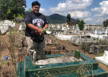 IBRAHIM Ariffin menunjukkan antara batu nisan di Tanah Perkuburan Islam Kampung Melayu di Kluang Johor  sengaja dirosakkan pihak tidak bertanggungjawab.