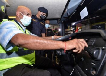 M. JANAGARAJAN (kiri) bersama Pengarah JPJ Negeri Sembilan, Hanif Yusabra Yusuf (tengah) memeriksa keadaan sebuah bas ekspres semasa Operasi Khas Hari Raya Aidiladha di Hentian Bas Terminal 1, Seremban, semalam. - FOTO/MOHD. SHAHJEHAN MAAMIN