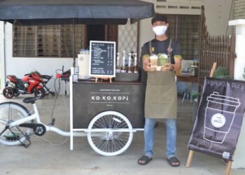 ZULHAZMAN Zainal Abidin di kedai kopi berkonsepkan basikal roda tiga di hadapan rumahnya di Taman Seri Pagi, Senawang, Negeri Sembilan-UTUSAN/ZAKKINA WATI AHMAD TARMIZI