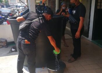 MOHD. Shahrin Mohd.Tamin (kanan) bersama pekerja di restorannya menadah air mengisi air di Restoran An-Nur Taman Sri Andalas di Klang, Selangor hari ini. - UTUSAN / ABDUL RAZAK IDRIS