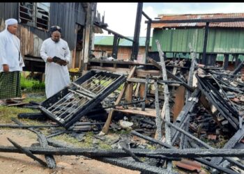 MOHD. Faizal Shafie (kanan) bersama dua pelajar melihat pondok yang musnah dalam kebakaran di Madrasah Islahiah Kampung Paya Kelubi, Sungai Karangan, Kulim, Kedah hari ini.