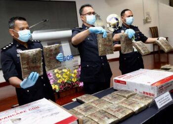 ABDUL Latiff Abdul Rahman (tengah) menunjukkan dadah mampat yang dirampas dalam sidang akhbar di Ibu Pejabat Polis Kontinjen Selangor, Shah Alam hari ini. - UTUSAN/SAIRIEN NAFIS