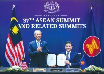 Perdana Menteri, Tan Sri Muhyiddin Yassin dan Menteri Perdagangan Antarabangsa dan Industri, Datuk Seri Mohamed Azman Ali selepas majlis menandatangani Perjanjian Perkongsian Ekonomi Komprehensif Serantau secara maya di Kuala Lumpur, Ahad lalu. – UTUSAN/ SHIDDIEQIIN ZON