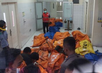 POLIS dan pihak hospital menyimpan mayat mangsa dalam beg khas di Hospital Tangerang.-AFP