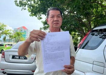 CHUA Beng Choon menunjukkan salinan laporan polis mendakwa ada individu menipu mengundi bagi pihaknya secara dalam talian di Kangar, Perlis hari ini.- UTUSAN/MOHD. HAFIZ ABD. MUTALIB