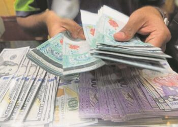 PENGURUP wang berlesen mengira mata wang ringgit yang
didagangkan lebih tinggi berbanding dolar Amerika Syarikat.
– GAMBAR HIASAN