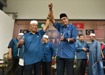 MUHYIDDIN Yassin mengangkat  tangan  Rosol Wahid selepas diumum  bertanding di  Parlimen Hulu Terengganu pada program Jejalah Prihatin dan Pelancaran Jentera PRU15 PN peringkat negeri di Kuala Berang, Hulu Terengganu.-UTUSAN/PUQTRA HAIRRY ROSLI