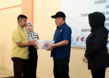 MOHAMAD Sabu (dua kanan) menyerahkan Kits Bantuan Bencana Banjir kepada warga MAFS Kelantan yang terjejas dengan banjir di pejabat FAMA Kota Bharu, Kelantan hari ini.-KAMARUL BISMI KAMARULZAMAN