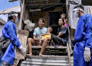SUKARELAWAN Semporna Heroes terdiri daripada pemain industri pelancongan mengagihkan susu tepung bagi keperluan anak-anak penduduk yang terjejas akibat pandemik Covid-19 di Kampung Mabul, Semporna, Sabah. –  UTUSAN/FAUZAN AZIMA