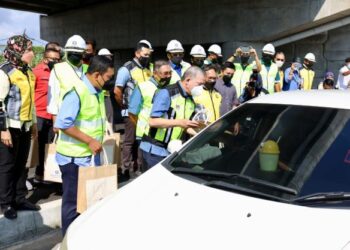FADILLAH Yusof (dua dari kanan) mengagihkan cenderahati kepada pengguna Jalan Sabak Bernam-Klang sewaktu Majlis Penyerahan dan Perasmian Projek Menaiktaraf Jalan Persekutuan itu di Sungai Besar, Selangor, hari ini. - FOTO/ZULFADHLI ZAKI