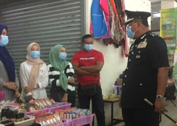 SHAFIEN Mamat (dua dari kanan) memberi penerangan berhubung pematuhan SOP dalam kalangan peniaga di Pasar Tasek Raja, Pasir Mas, Kelantan