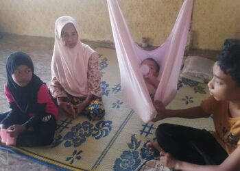 RAMLAH Hasan (dua dari kiri) bersama tiga daripada empat cucu di rumahnya Kampung Betong, Hulu Terengganu. – FOTO/NOOR HAYATI MAMAT