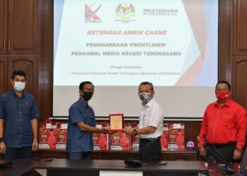 RAZALI Idris (dua, kanan) menyampaikan cenderamata kepada  Nik Muhamad Zaid Nik Salim dalam Program Ketengah Ambil Cakna kepada Pengamal Media Terengganu di Pejabat Ketengah Holdings di Kuala Terengganu, hari ini.- UTUSAN/PUQTRA HAIRRY ROSLI