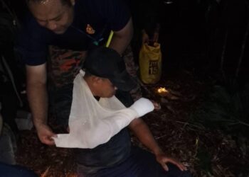 ANGGOTA pasukan bomba dan penyelamat membantu seorang anggota PGA yang cedera dipercayai dipatuk ular kapak di tangan kanannya di Hutan Simpan Ulu Muda, Gubir, Sik, Kedah, semalam.  