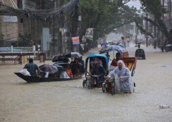 PENDUDUK meredah banjir di Sylhet, Bangladesh. - AFP