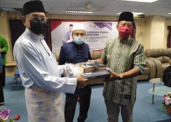 ABDUL RAHMAN Mohamad (kanan) dan disaksikan Mustapa Long (tengah) sedang menyampaikan bantuan komputer riba dan alat pencetak kepada Zulkifli Othman (kiri) di Lipis, Pahang. 
UTUSAN/HARIS FADILAH AHMAD