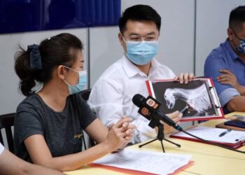 LAW Euo Nan (kanan) bersama Chong Kwai Siew menunjukkan imbasan x-ray anjing yang ditembak mati menggunakan pistol angin pada sidang akhbar di bangunan MCA Perak, Ipoh hari ini. - UTUSAN/ ZULFACHRI ZULKIFLI