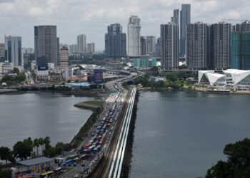 KENDERAAN beratur panjang sebelum memasuki pusat pemeriksaan Woodlands di Singapura.-AFP