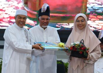 AHMAD Zahid Hamidi menyampaikan tokoh personaliti Quran kepada Norhafizah Musa pada Majlis Anugerah Personaliti Quran dan Wakaf al-Qur’an di Kompleks Nasyrul Quran, Putrajaya. - UTUSAN/MOHD HUSNI MOHD NOOR